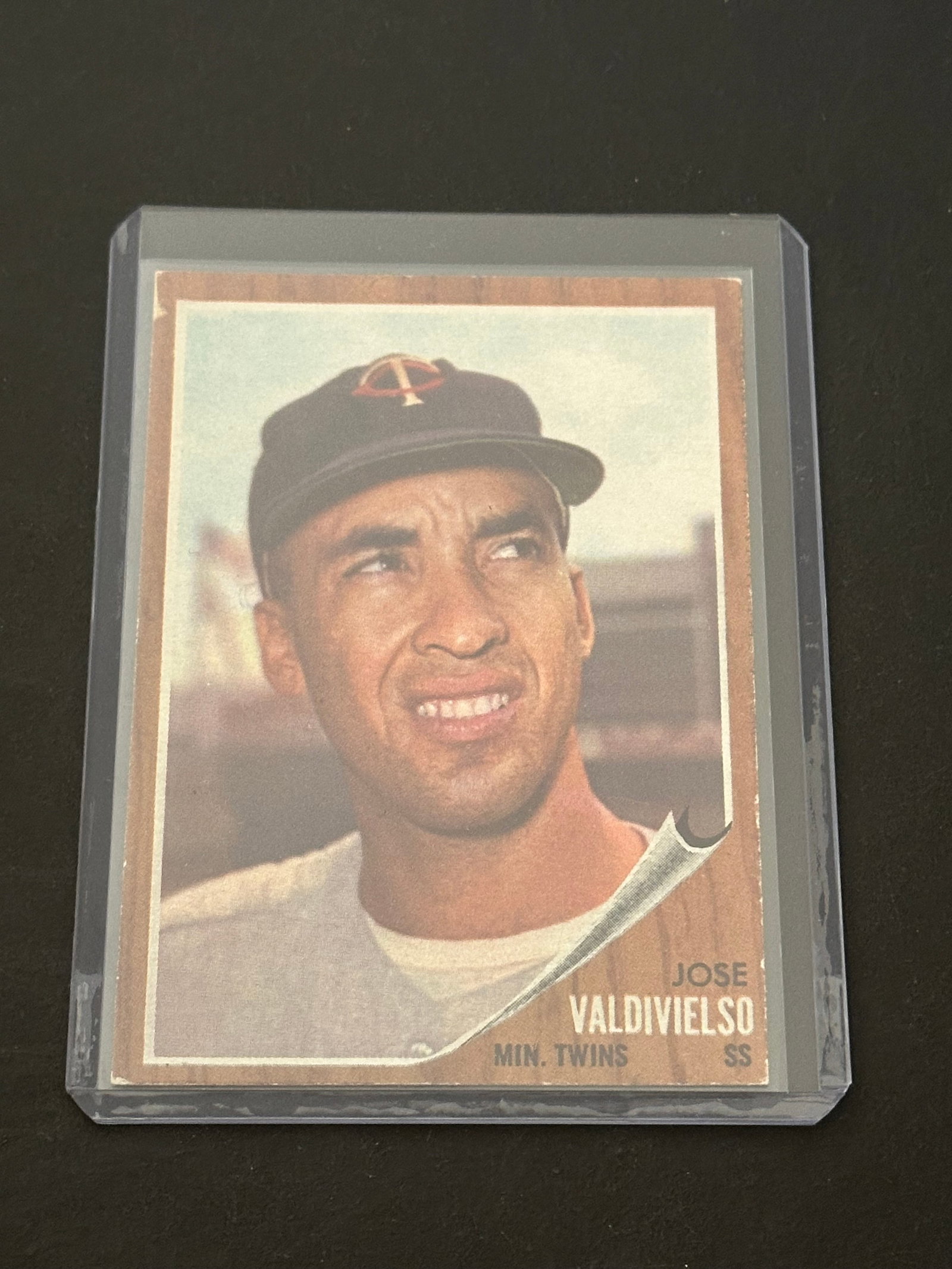 1962 Topps Jose Valdivielso Minnesota Twins Baseball Card: This is a 1962 Topps baseball card featuring Jose Valdivielso of the Minnesota Twins. The card displays a vintage wood-grain border design and is protected in a hard plastic top loader. It shows