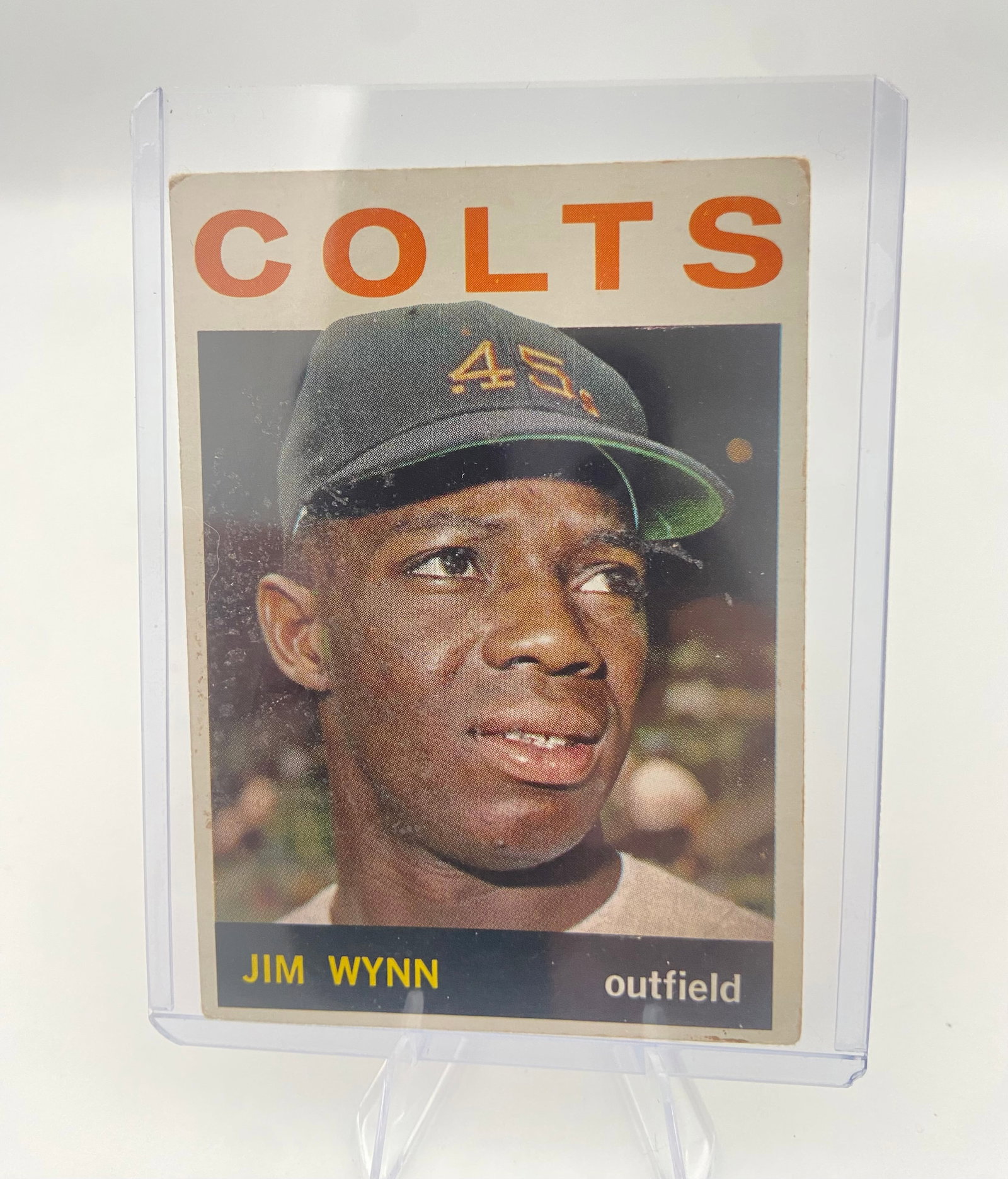 1964 Topps Jim Wynn Houston Colt .45s Baseball Card: This is a 1964 Topps baseball card featuring Houston Colt .45s outfielder Jim Wynn. The vintage card displays a portrait of the player under the bold orange 'COLTS' team heading and shows signs of