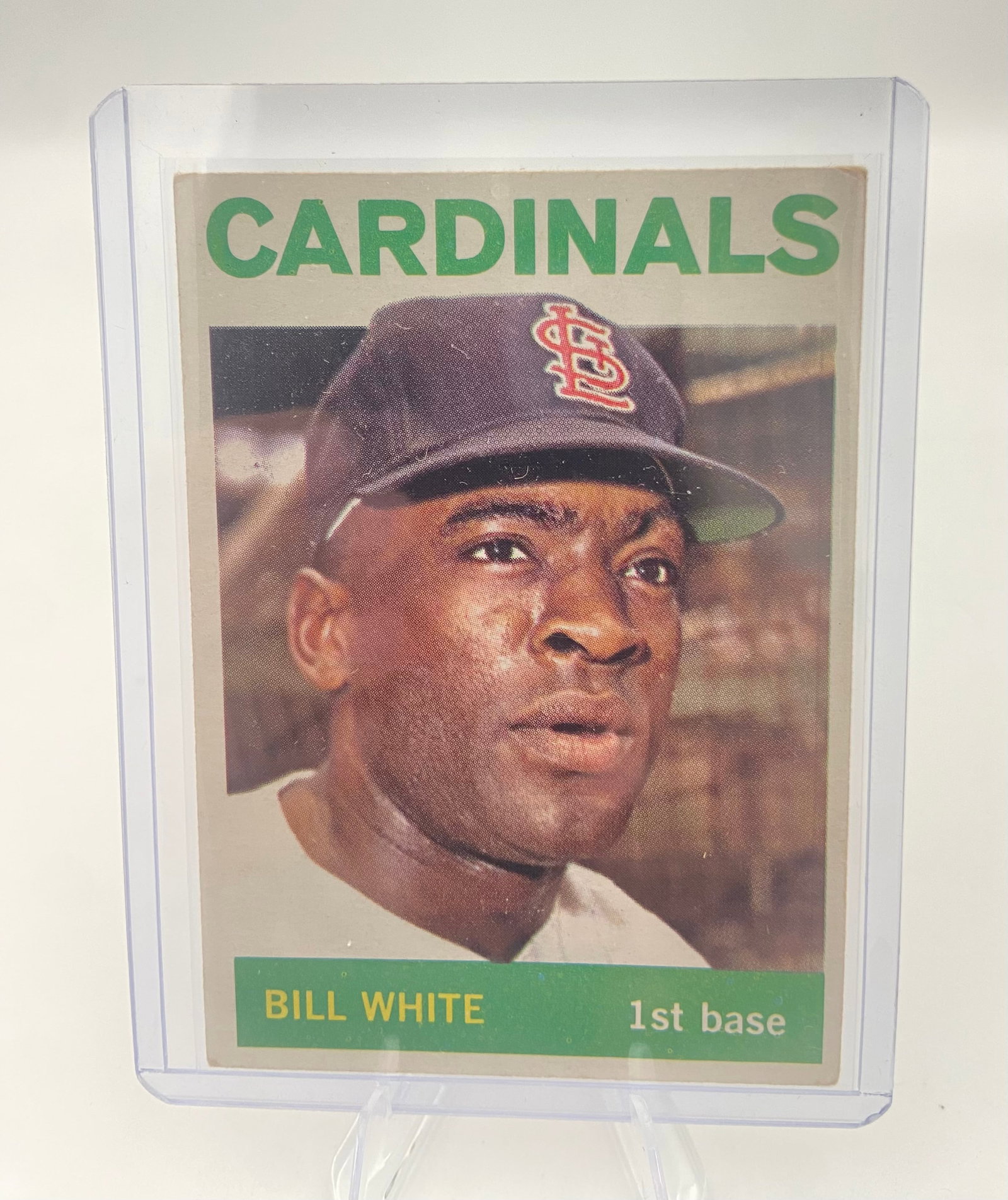 1964 Topps Bill White St. Louis Cardinals Baseball Card: 1964 Topps baseball card featuring St. Louis Cardinals first baseman Bill White. The card is in vintage condition and is displayed in a protective hard plastic top loader.