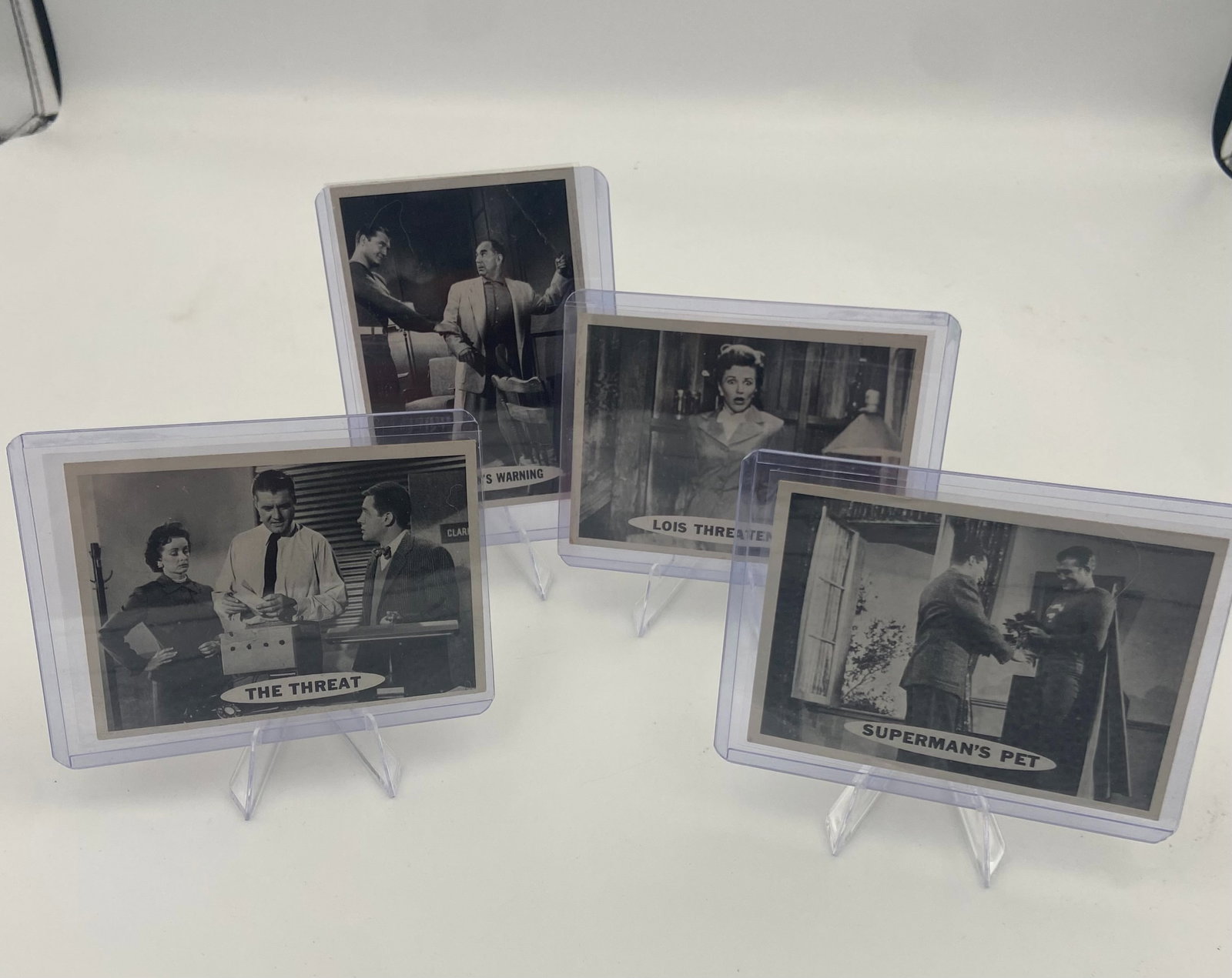 Adventures of Superman Trading Cards: A collection of vintage black and white trading cards featuring scenes from the Adventures of Superman television series. The cards include titled scenes such as 'The Threat', 'Lois Threatened', and