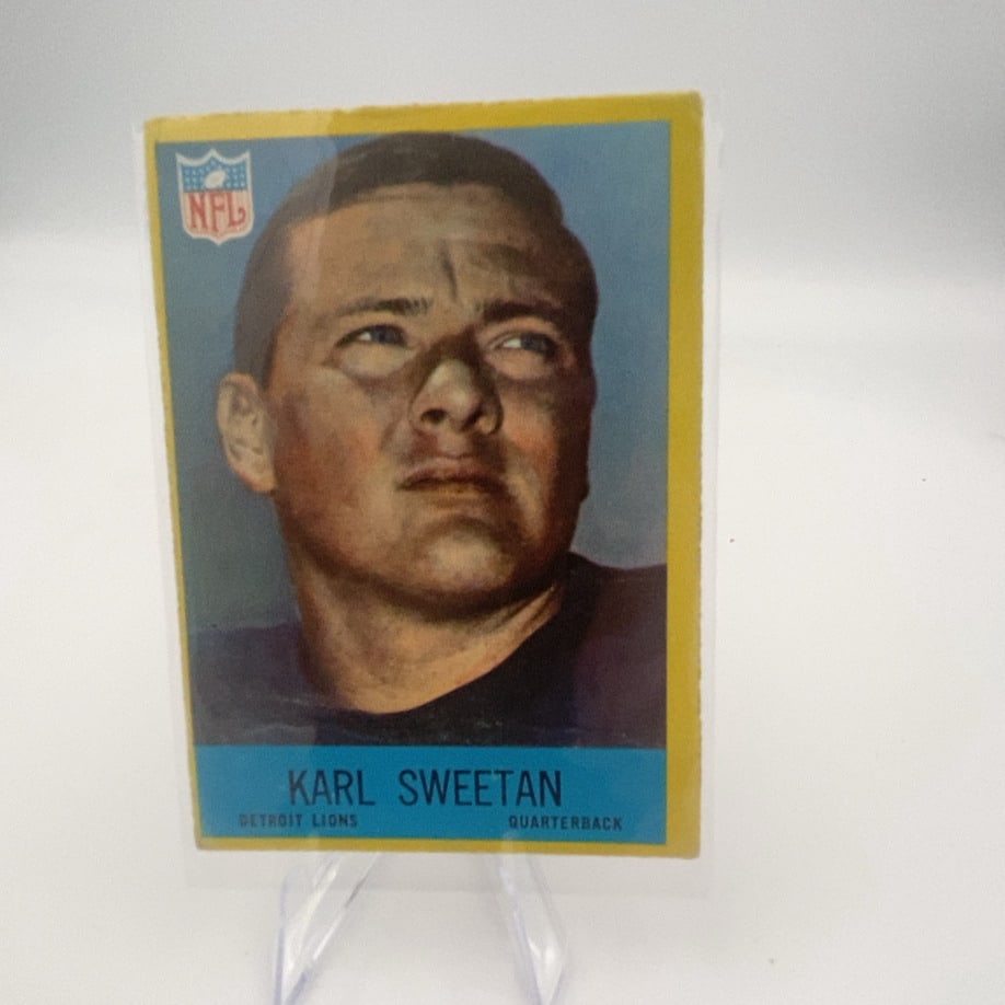 1967 Philadelphia Karl Sweetan Football Card: This is a 1967 Philadelphia football card featuring Detroit Lions quarterback Karl Sweetan. The card displays a portrait-style headshot with the iconic yellow and blue border design characteristic of