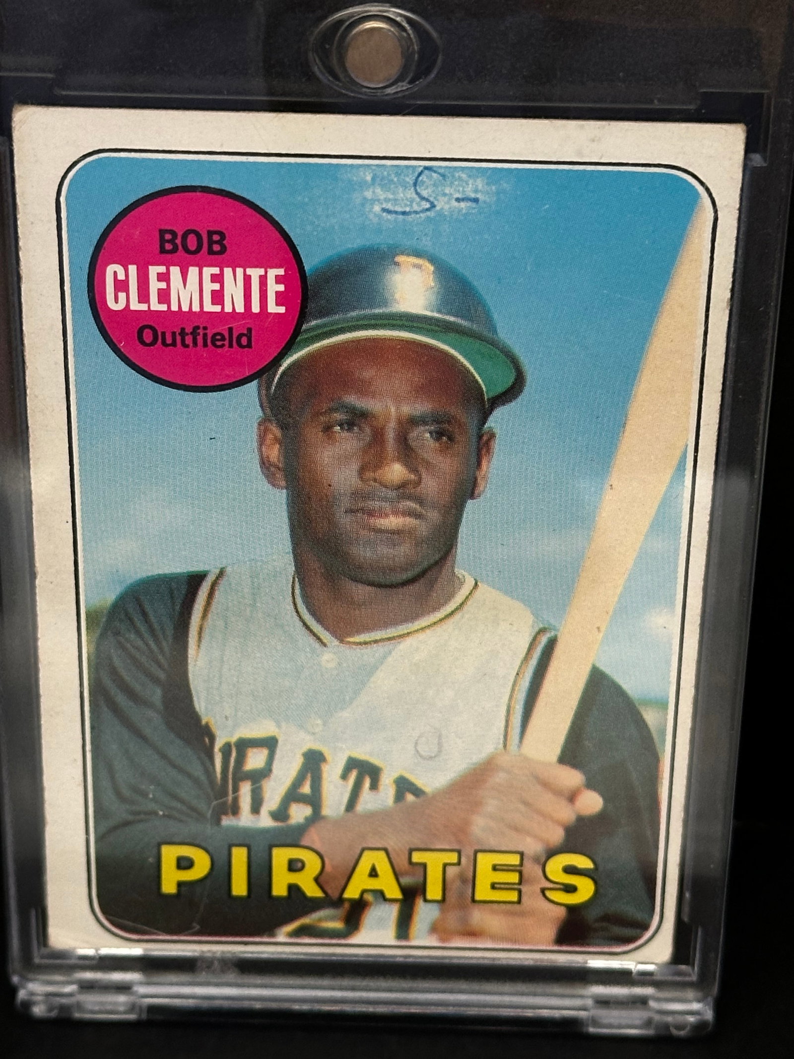 1971 Topps Roberto Clemente Baseball Card: This is a 1971 Topps Roberto Clemente baseball card featuring the Hall of Fame Pittsburgh Pirates outfielder. The card shows signs of wear, including visible ink markings or staining on the top left b