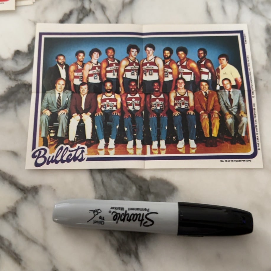 1969 Topps Bullets Team Pin-Up: This is a 1980s Topps team pin-up featuring the Washington Bullets basketball team. The item shows players in their uniforms alongside coaching staff and includes the year and branding printed on the 