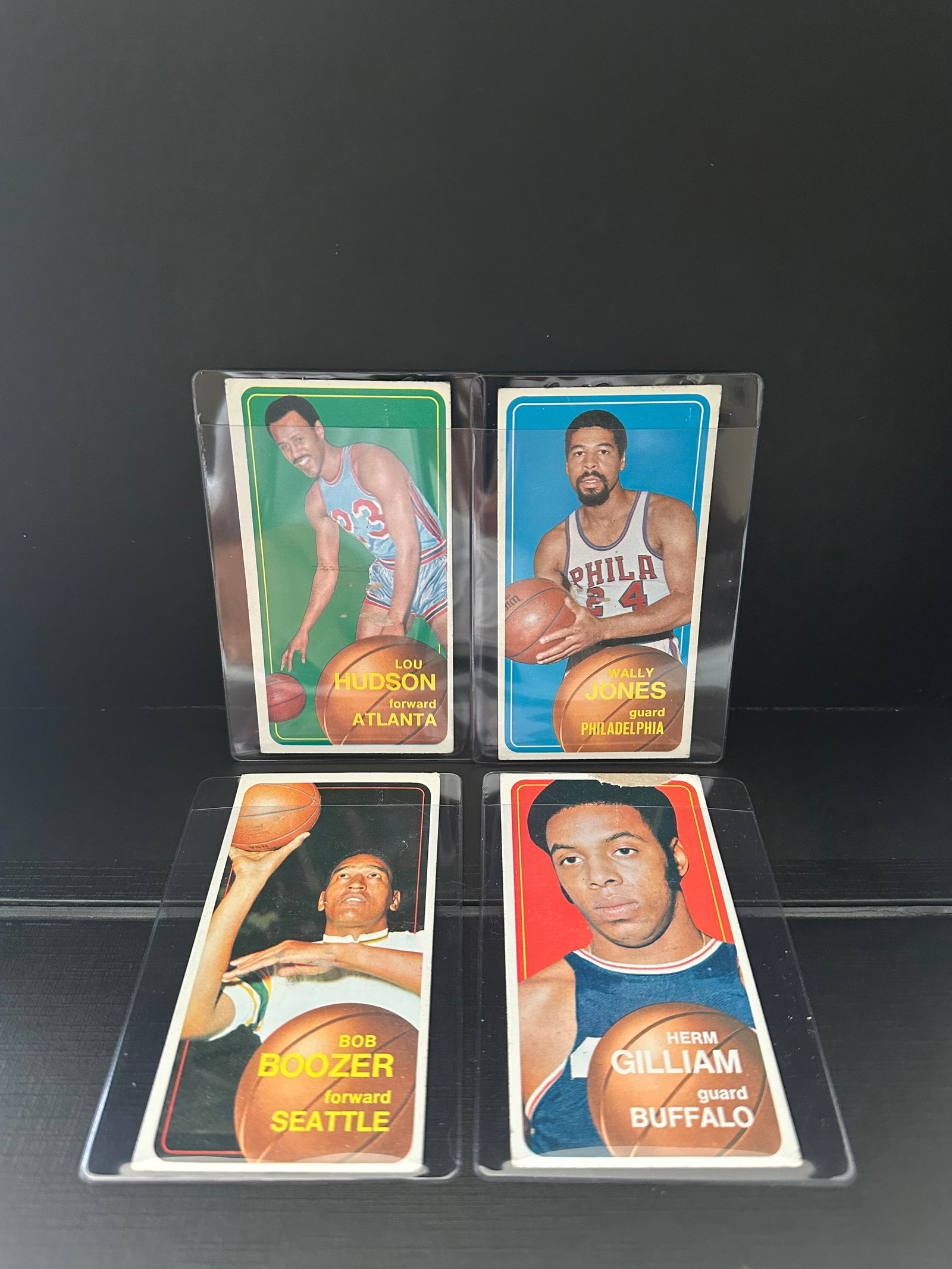1969 Topps Basketball Multiple Player Lot: This lot features four basketball trading cards from the 1969 Topps set. The cards include Wally Jones of the Philadelphia 76ers, Herm Gilliam of the Buffalo Braves, Lou Hudson of the Atlanta Hawks,