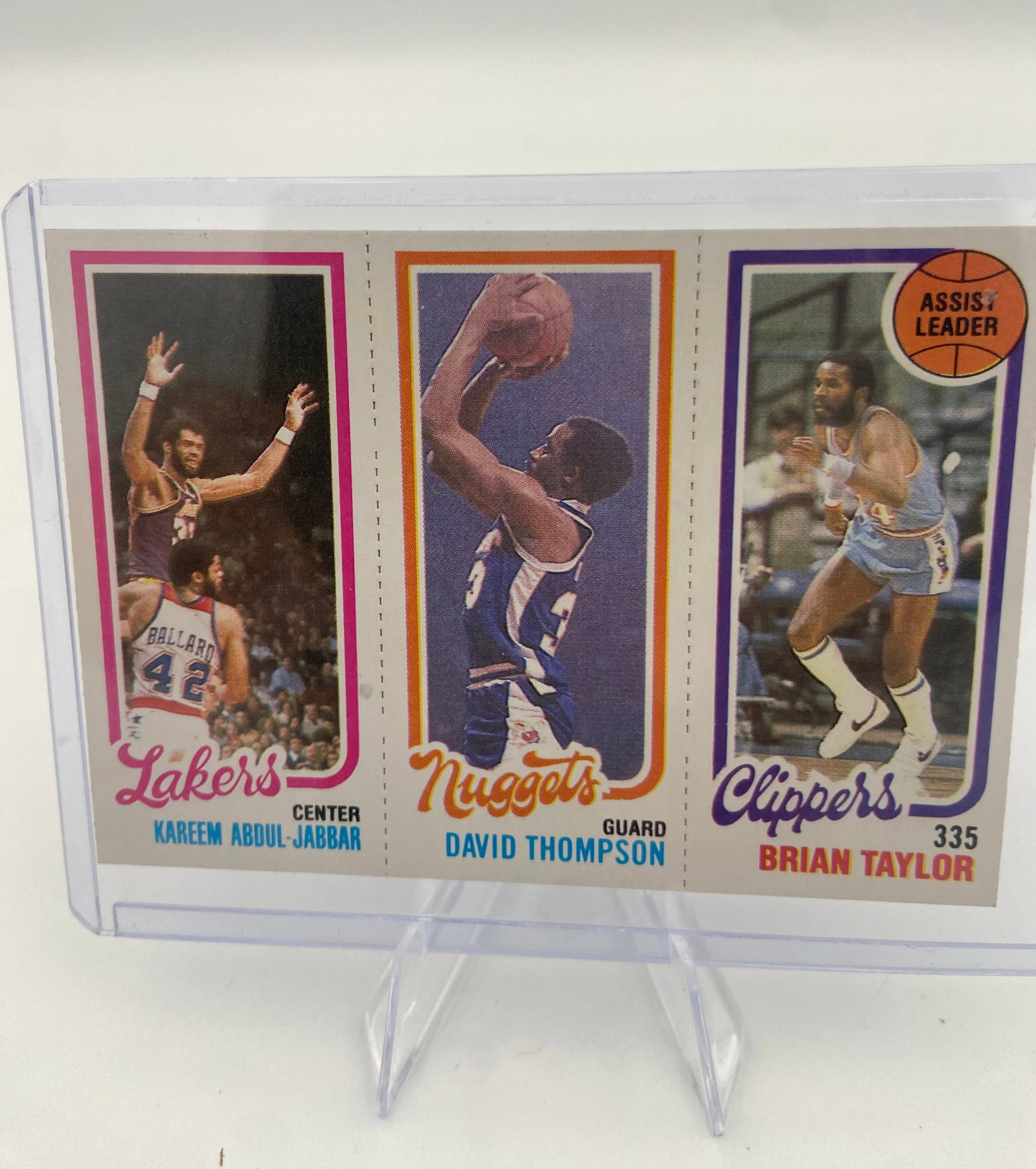 1977 Topps Kareem Abdul-Jabbar David Thompson Brian Taylor: This is a 1977 Topps basketball card featuring three notable players: Kareem Abdul-Jabbar, David Thompson, and Brian Taylor. The card displays individual action shots for each player along with their 