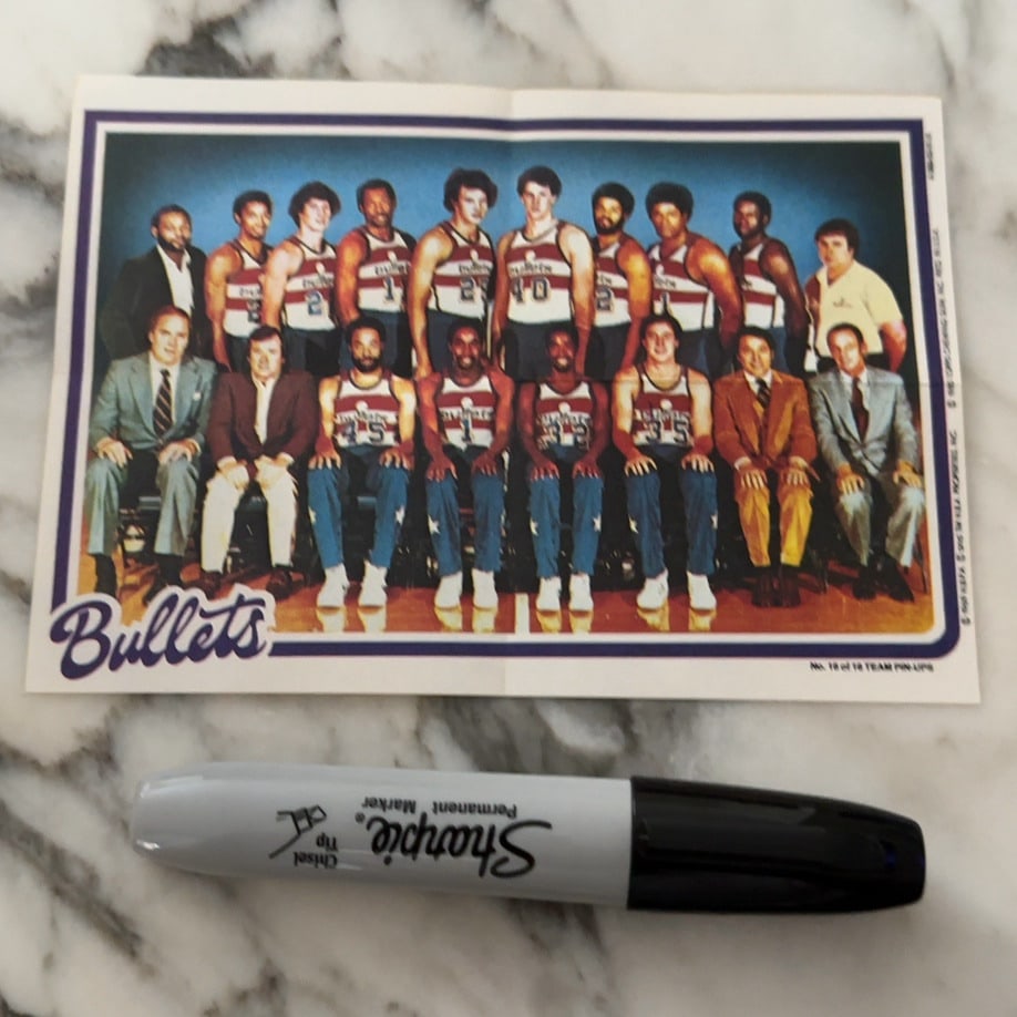 1985 Topps Washington Bullets Team Pin-Ups: This is a 1985 Topps Washington Bullets team pin-up, marked as number 18 of 18 in the set. The image features a full team photograph with the Washington Bullets logo in the lower left corner. The