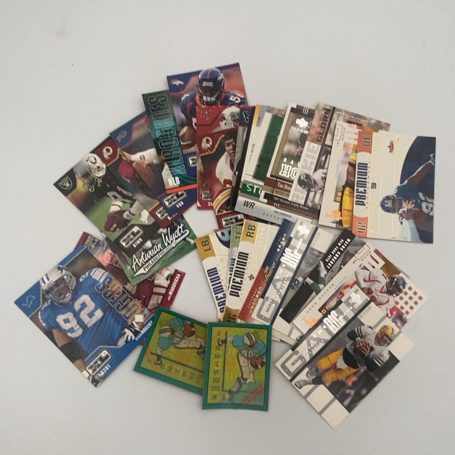 Mixed Lot of Football Trading Cards: This is a collection of various football trading cards from different manufacturers and years. The assortment includes cards from brands like Topps, Prestige, and XL, featuring players from multiple