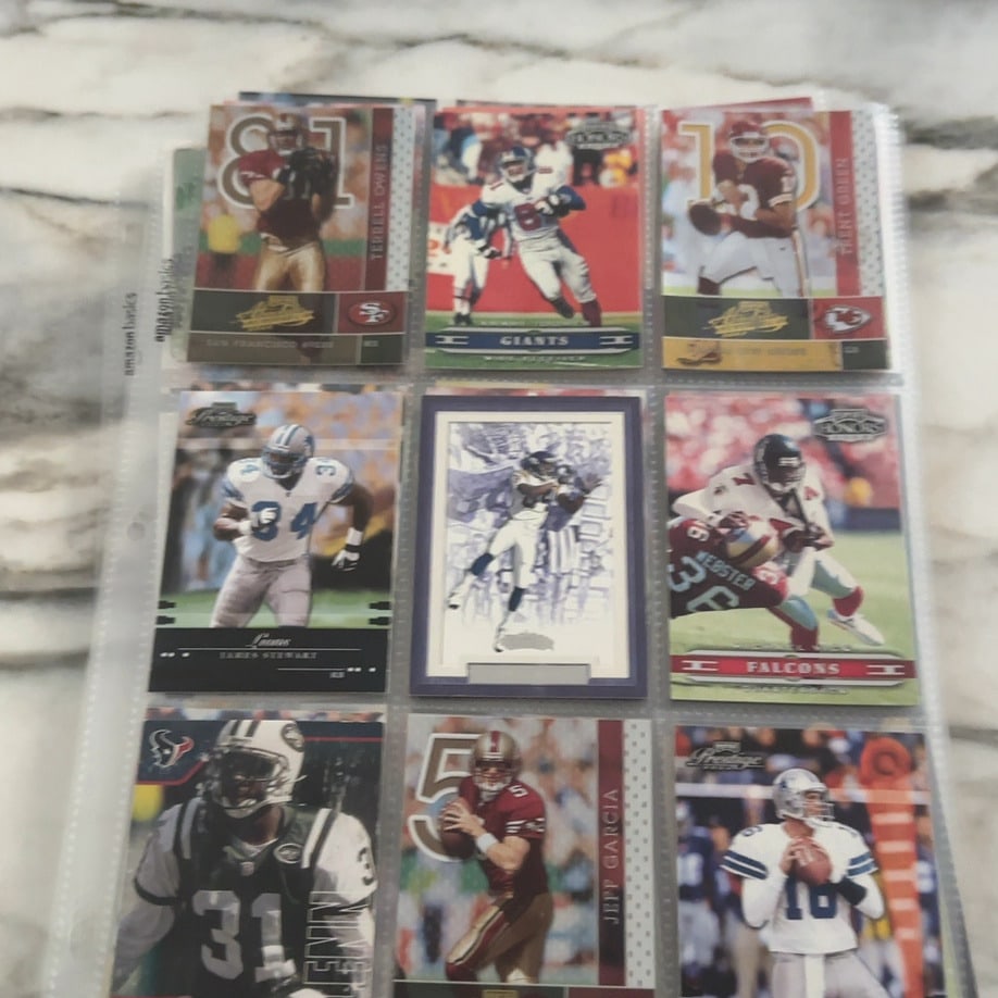 2000s NFL Football Trading Card Collection Page: This is a collector's page containing a variety of football trading cards from the early 2000s. The collection features players such as Terrell Owens, Jeff Garcia, and various team players from sets