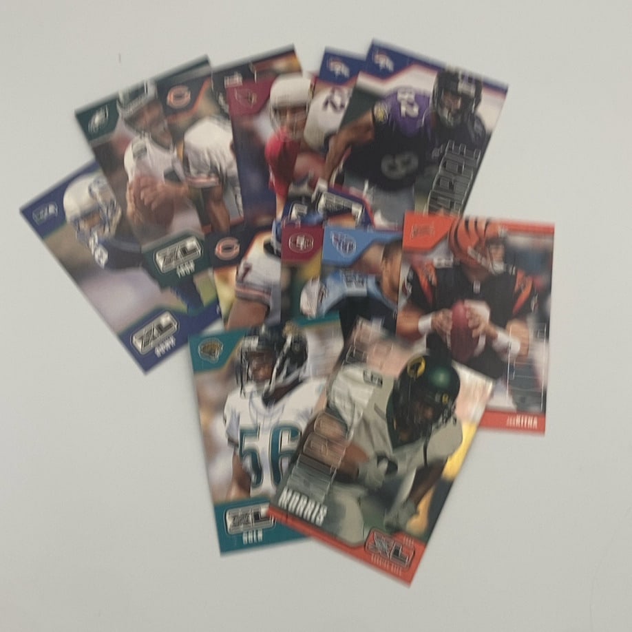 1999 Topps XXL Football Cards: This is a collection of 1999 Topps XXL football cards featuring various players. The cards prominently display the 'Topps XXL' logo on the front.