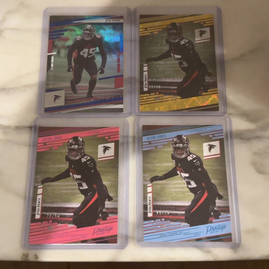 2021 Panini Prestige Deion Jones Parallel Card Lot: This lot features four different Deion Jones Xtra Points parallel cards from the 2021 Panini Prestige football set. The cards showcase the Atlanta Falcons linebacker and include various serialized