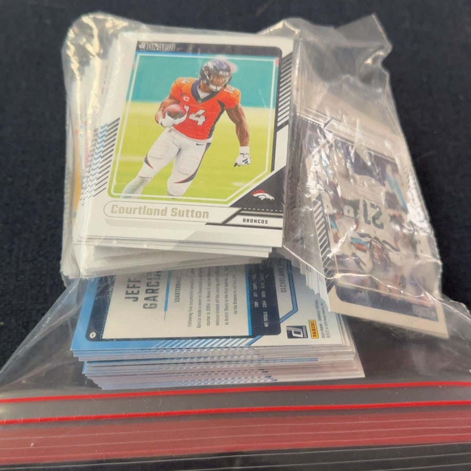 Bag Full of 2024 Panini Donruss football trading cards.: A sealed clear plastic bag containing a collection of 2024 Panini Donruss football trading cards. The top card visible is Courtland Sutton of the Denver Broncos. This is the back of a 2023 Donruss