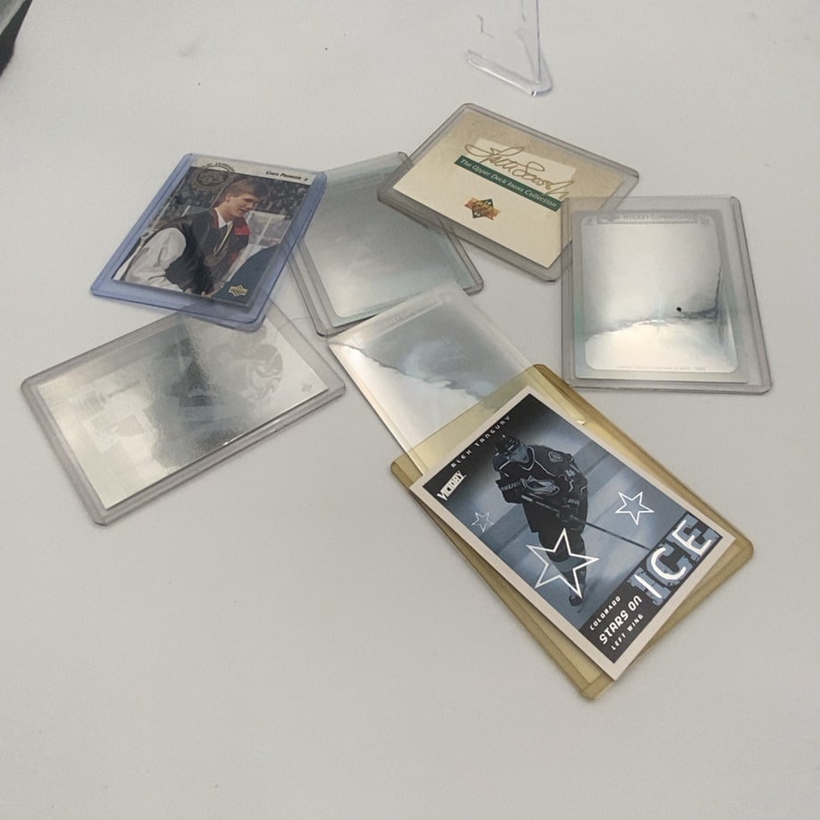 Alex Tanguay Stars on Ice Trading Card: a collection of hockey trading cards featuring Alex Tanguay and Chris Pronger. The cards are enclosed in individual plastic protective sleeves for preservation. The primary visible card features Alex