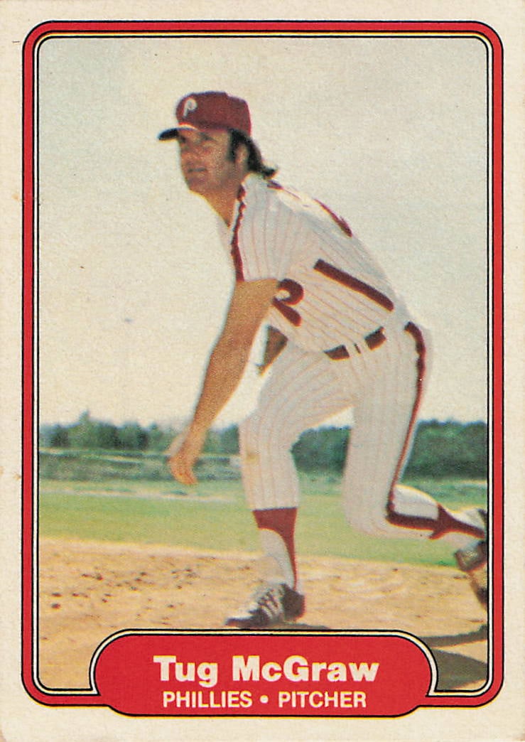 1975 Topps Tug McGraw: This is a 1975 Topps baseball card featuring Philadelphia Phillies pitcher Tug McGraw. The front of the card shows McGraw in his pitching stance while wearing the Phillies pinstriped uniform.