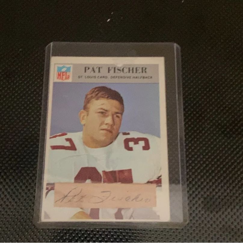 1963 Topps NFL St. Louis Cardinals Pat Fischer Card: This is a 1963 Topps NFL football card featuring St. Louis Cardinals defensive halfback Pat Fischer. The card displays a portrait of the player with his printed autograph on a tab at the bottom. It