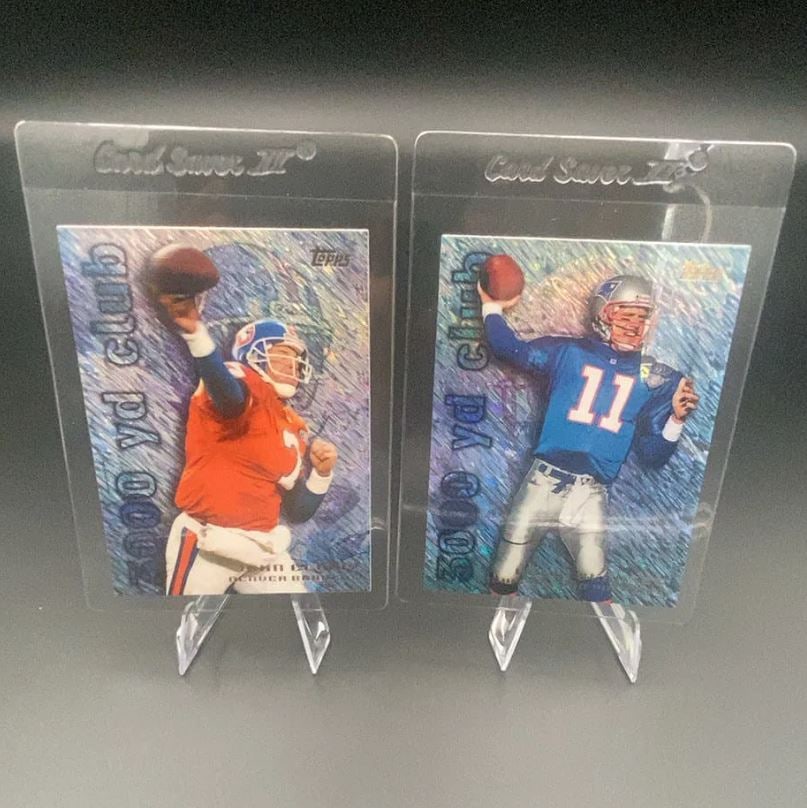 Topps 3000 Yd Club John Elway and Drew Bledsoe: Two Topps 3000 Yard Club trading cards featuring football players John Elway of the Denver Broncos and Drew Bledsoe of the New England Patriots. Both cards are housed in protective plastic sleeves