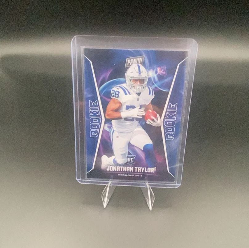 2020 Panini Jonathan Taylor: This is a 2020 Panini rookie trading card featuring Indianapolis Colts running back Jonathan Taylor. The card displays a dynamic graphic design and prominently labels him as a rookie.