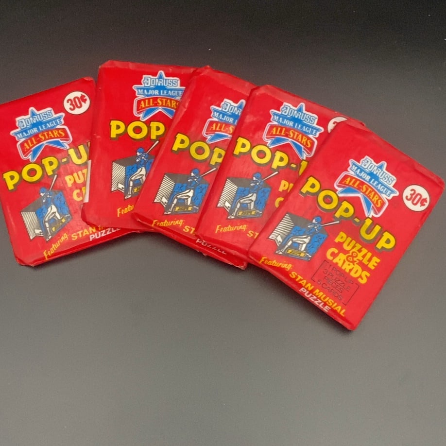 Donruss Major League All-Stars Pop-Up Puzzle & Cards: This lot includes five unopened vintage wax packs of Donruss Major League All-Stars Pop-Up Puzzle & Cards. Each pack is marked with a 30-cent price and features a Stan Musial puzzle. These packs conta