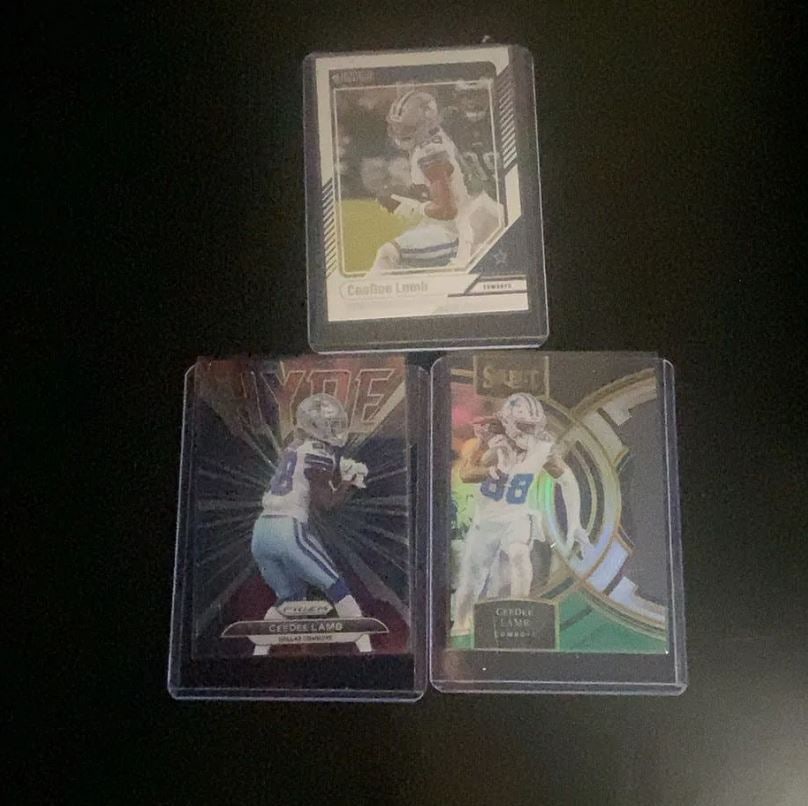 2020 Panini CeeDee Lamb Trading Card Collection: This image features three distinct trading cards of Dallas Cowboys wide receiver CeeDee Lamb. The collection includes cards from Panini Score, Panini Prizm, and Panini Select brands. These cards