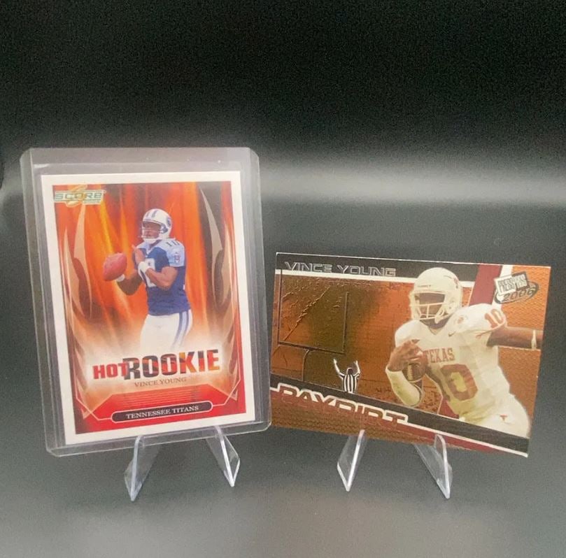 2006 Score and Press Pass Vince Young Cards: This lot features two football trading cards of Vince Young. One is a 2006 Score Hot Rookie card representing the Tennessee Titans, and the other is a 2006 Press Pass Paydirt card featuring Young in