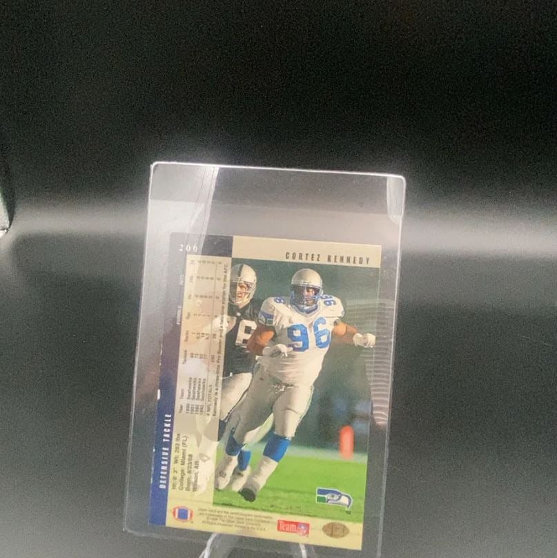 1994 Upper Deck Cortez Kennedy: This is a 1994 Upper Deck football card featuring defensive tackle Cortez Kennedy of the Seattle Seahawks. The card displays the player in action on the field along with his career statistics printed