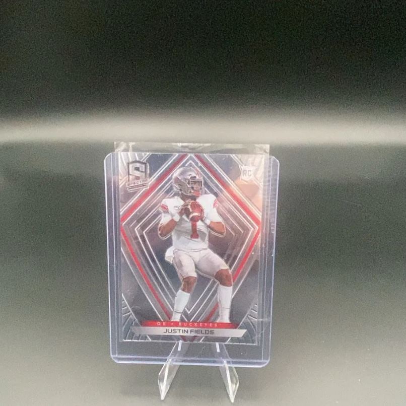 2021 Panini Spectra Justin Fields: This is a 2021 Panini Spectra football trading card featuring Justin Fields, the quarterback for the Ohio State Buckeyes. The card is labeled with the 'RC' rookie logo and showcases the distinctive