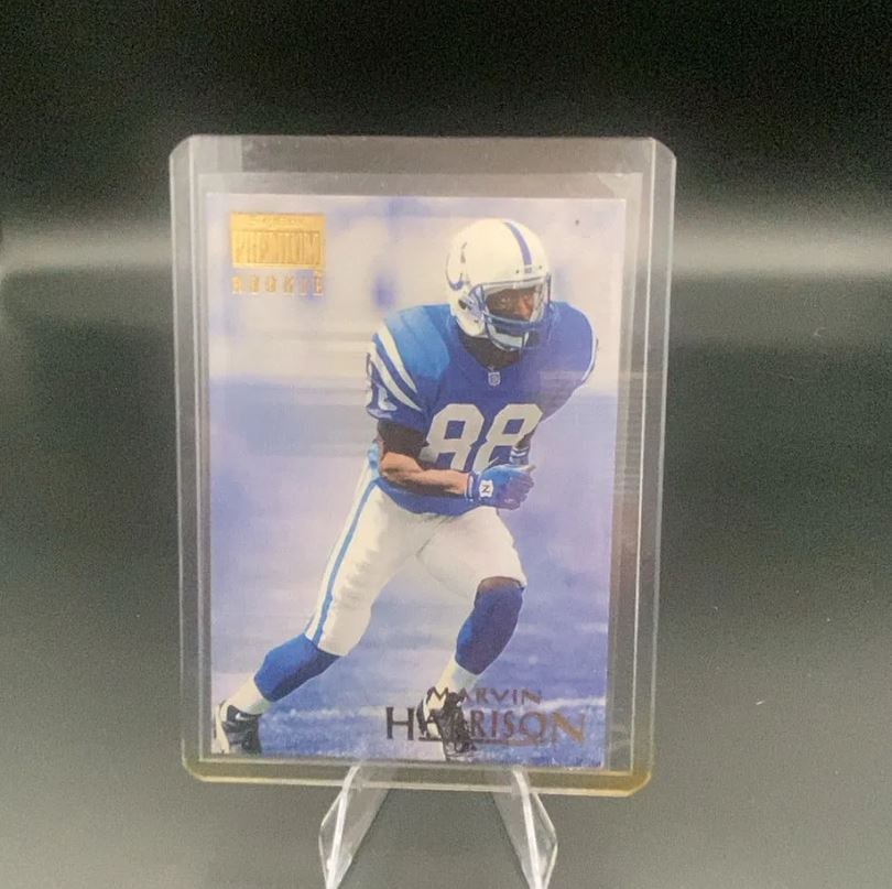 1996 SkyBox Premium Marvin Harrison: This is a 1996 SkyBox Premium rookie trading card featuring Indianapolis Colts wide receiver Marvin Harrison. The card features a clear photo of the athlete in his blue uniform and displays a