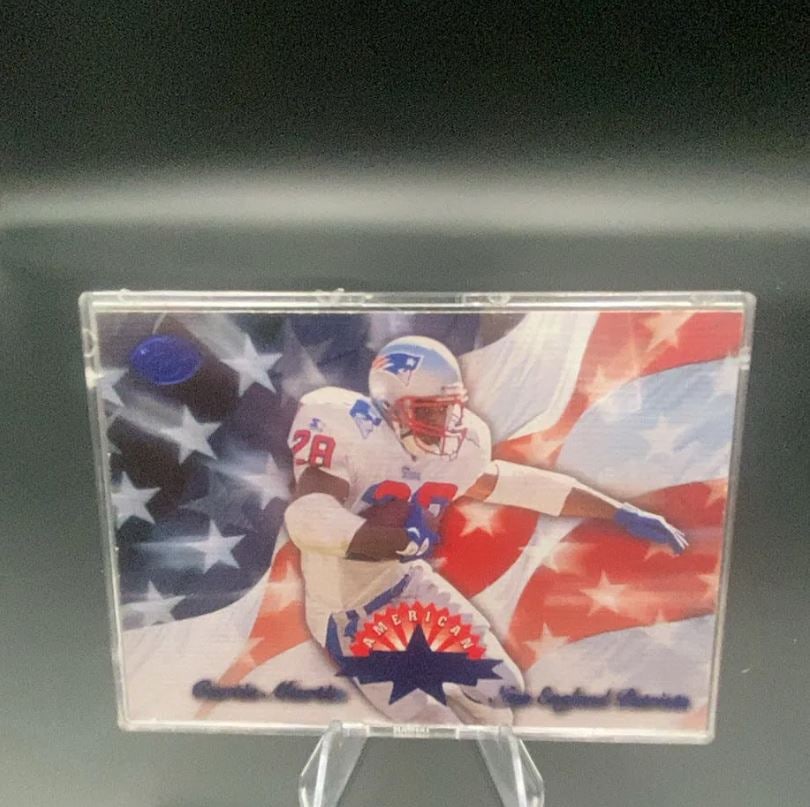 1997 Pacific American Curtis Martin: This is a 1997 Pacific football card featuring Curtis Martin of the New England Patriots. The card features a patriotic American flag background and is housed in a clear protective case.