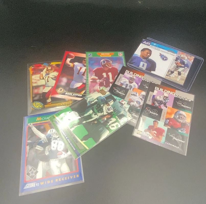 Assorted NFL Football Trading Card Collection: This is a collection of various NFL football trading cards, including players such as Mark Rypien, Michael Irvin, Steve McNair, and others. The cards feature brands such as Score and Upper Deck and