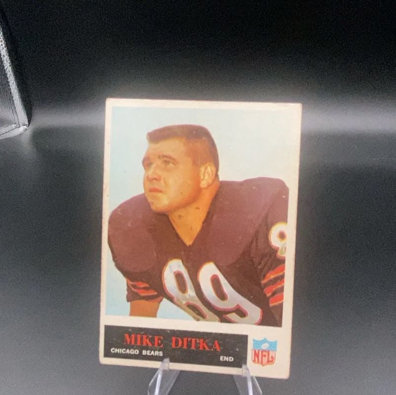 Mike Ditka Chicago Bears: A vintage football card featuring Hall of Famer Mike Ditka of the Chicago Bears. The card displays him in his team uniform with his player name and position clearly printed at the bottom.