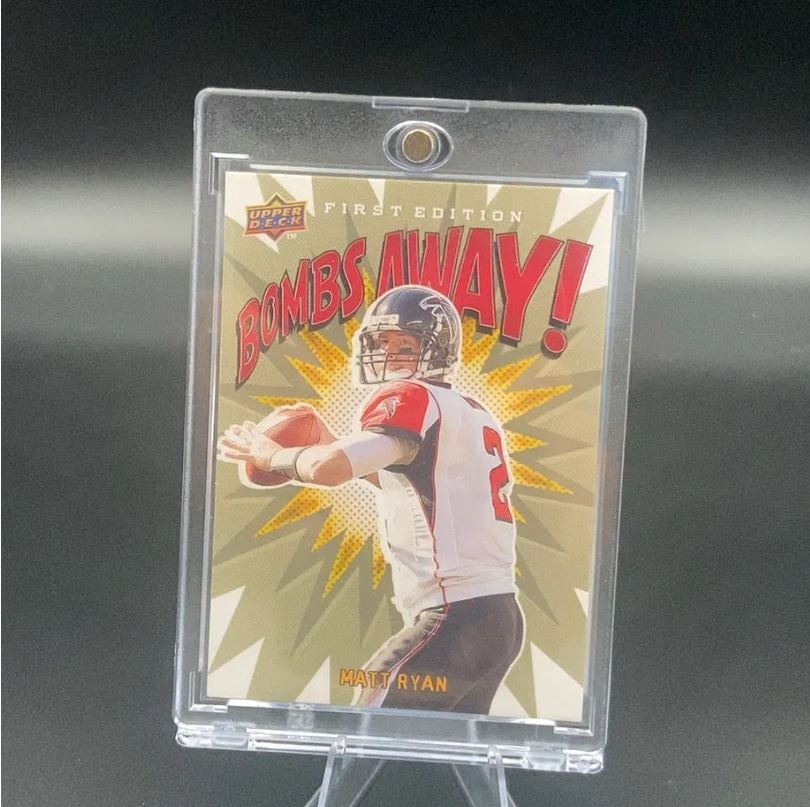Upper Deck First Edition Bombs Away Matt Ryan: This is a 2008 Upper Deck First Edition trading card featuring Matt Ryan from the Atlanta Falcons. The card is part of the Bombs Away insert set and is encased in a protective magnetic slab.