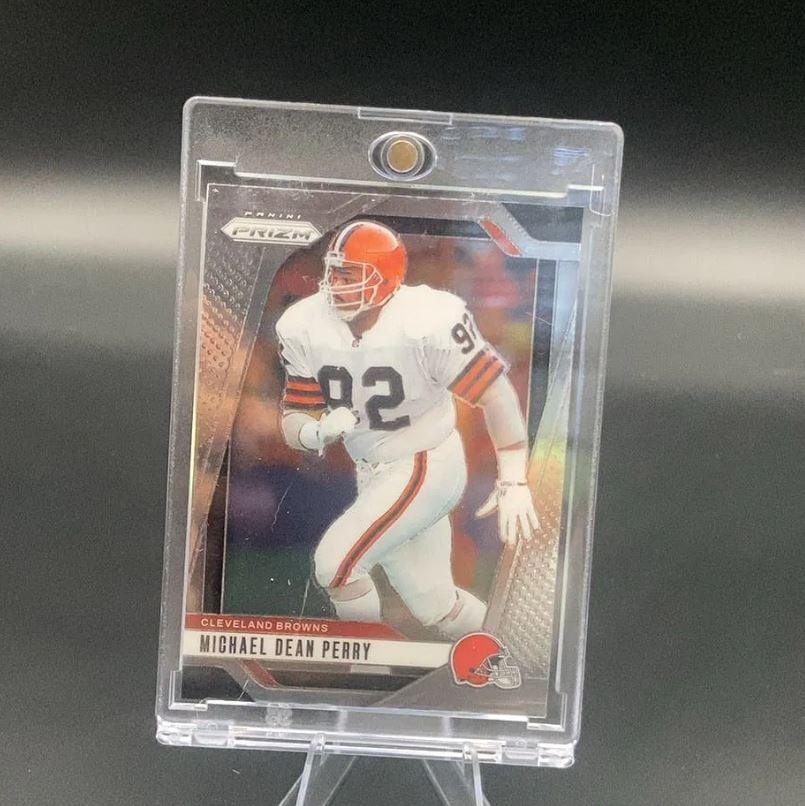 Panini Prizm Michael Dean Perry: This is a Panini Prizm trading card featuring Cleveland Browns player Michael Dean Perry. The card is encased in a protective magnetic holder. The design features a metallic Prizm aesthetic.