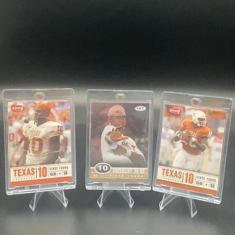 2006 Aspire and Hit Vince Young Cards: This image features three football trading cards showcasing Vince Young of the Texas Longhorns. It includes two cards from the Aspire brand and one card from the Hit set, all dated 2006. The cards