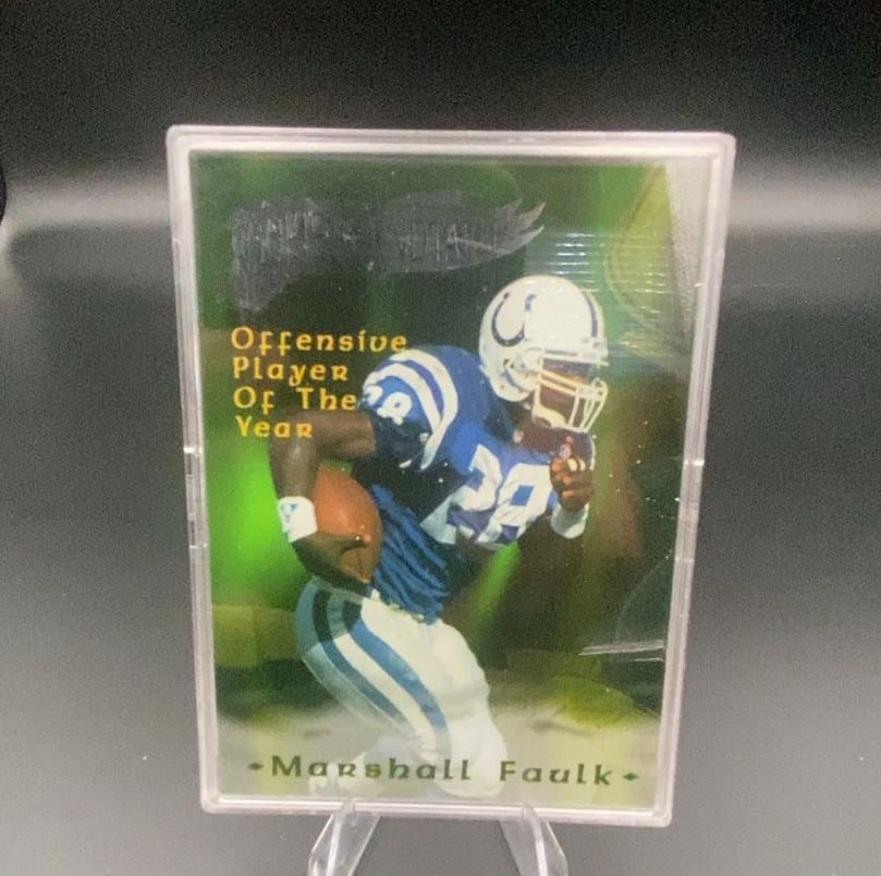 Marshall Faulk Indianapolis Colts Offensive Player Year Card: This is a collectible trading card featuring NFL player Marshall Faulk in his Indianapolis Colts uniform. The front of the card highlights him as an 'Offensive Player Of The Year' award recipient.