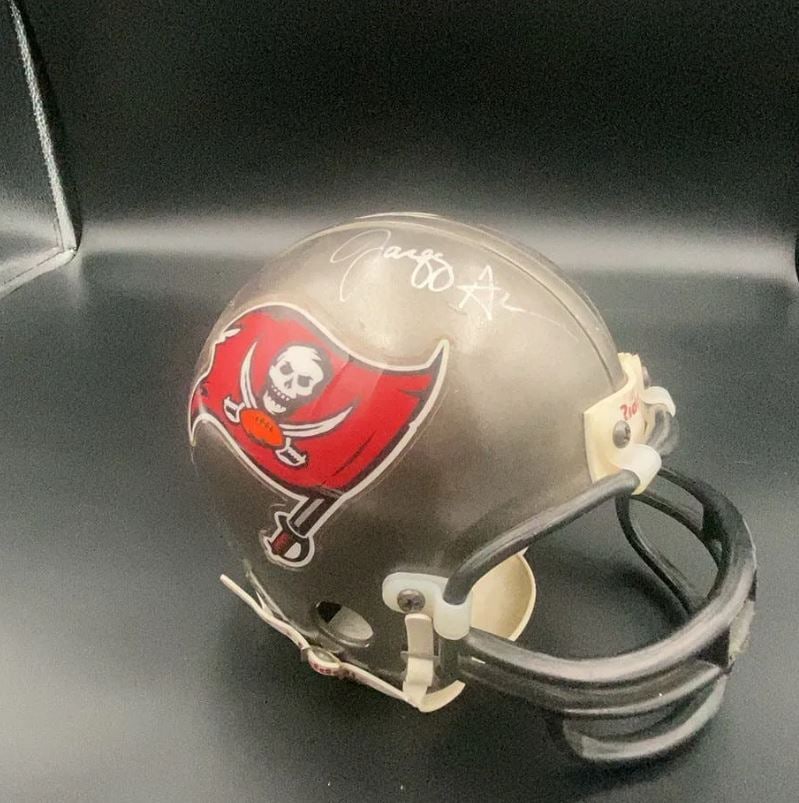 Tampa Bay Buccaneers Mini Helmet: This is a collectible Tampa Bay Buccaneers mini football helmet. It features the team logo on the side and a signature on the top.