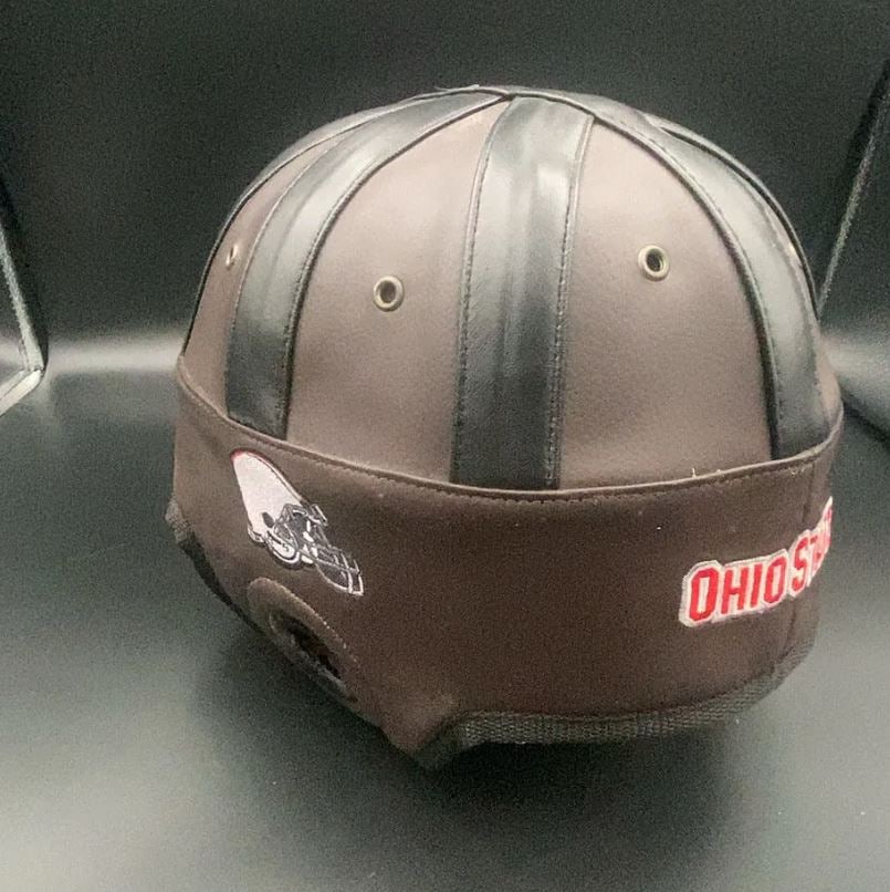 Ohio State Football Leather Helmet: This is a vintage-style leather football helmet featuring the Ohio State University team name embroidered on the side. The helmet includes a small graphic representation of a football helmet and
