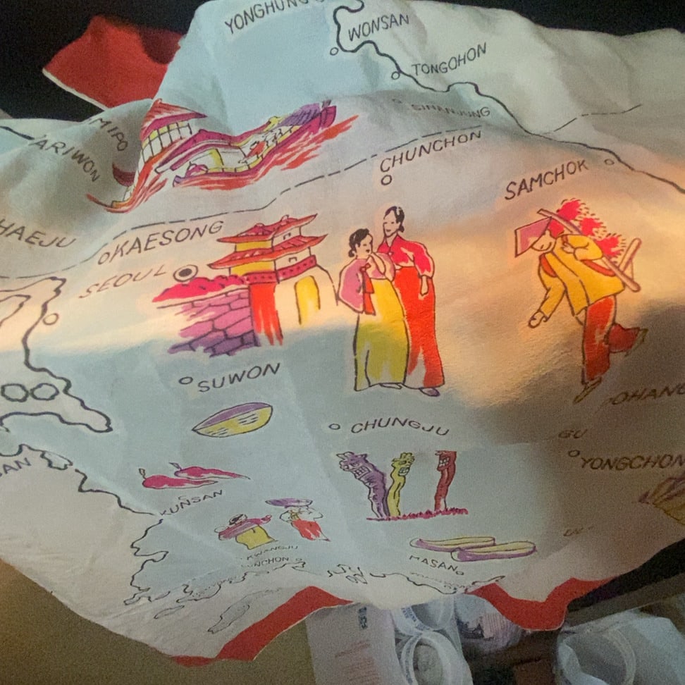 Vintage Korea Illustrated Map Souvenir Scarf: This is a vintage souvenir scarf featuring an illustrated map of Korea. The print includes iconic cultural depictions such as traditional hanbok-clad figures, architecture, and geographical locations