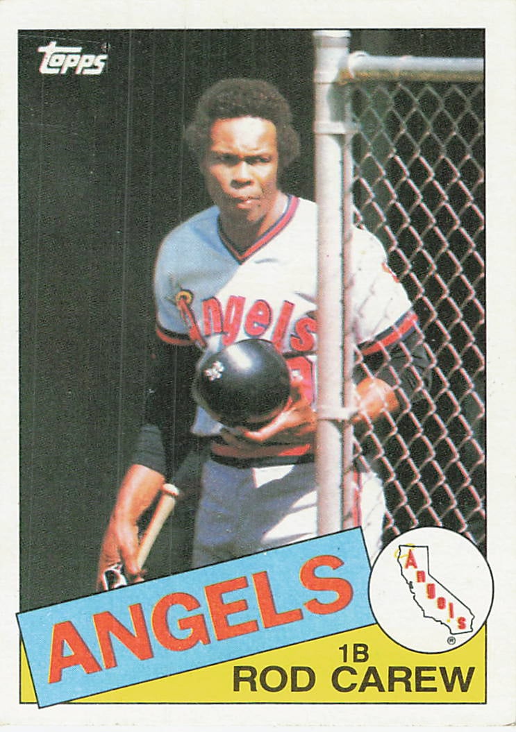 1985 Topps Tiffany 300 Rod Carew: This is a 1985 Topps baseball card featuring Hall of Famer Rod Carew playing for the California Angels, card number 230. The image captures Carew holding a batting helmet and bat near the dugout