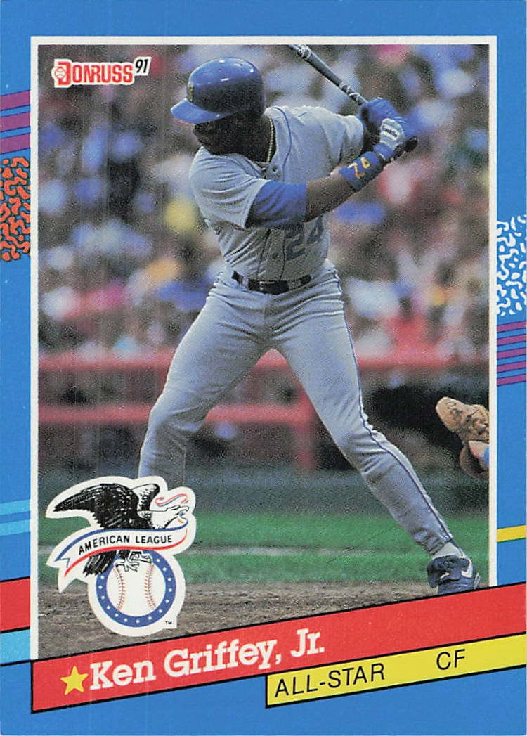 1991 Donruss Ken Griffey Jr. All-Star Baseball Card: This is a 1991 Donruss baseball card featuring Hall of Famer Ken Griffey, Jr. The card is identified as the All-Star subset card, showcasing Griffey in his Seattle Mariners uniform during a batting