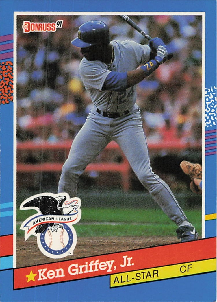 1991 Donruss Ken Griffey Jr. All-Star Baseball Card: This is a 1991 Donruss baseball card featuring Hall of Famer Ken Griffey, Jr. The card showcases Griffey in his center fielder position, designated as an All-Star. It is a standard issue card from