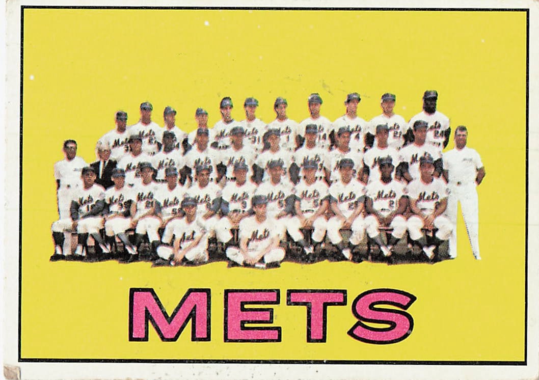 1967 Topps New York Mets Team Card: 1967 Topps New York Mets Team Card, card number 426 in the set. The card features a classic team portrait photo set against a vibrant yellow background with the team name 'METS' displayed vertically