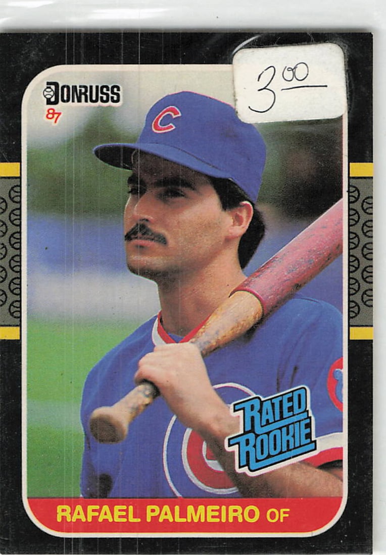 1987 Donruss Rafael Palmeiro Rated Rookie Card: This is a 1987 Donruss Rated Rookie trading card featuring Rafael Palmeiro, card number 36. The card captures the outfielder in his Chicago Cubs uniform, highlighting his early career status. It
