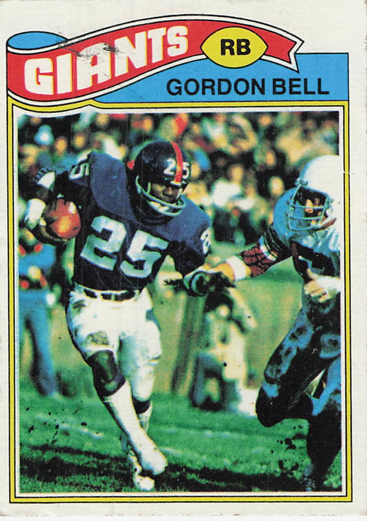 1977 Topps Gordon Bell New York Giants Football Card #235: This is a 1977 Topps football card featuring running back Gordon Bell of the New York Giants, card number 235. The card displays a dynamic action shot of Bell carrying the football while being