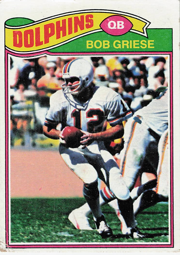 1977 Topps Bob Griese Miami Dolphins Football Card: This is a 1977 Topps football card, number 130, featuring Hall of Fame quarterback Bob Griese of the Miami Dolphins. The card showcases a classic action shot of Griese in his home white jersey prepari