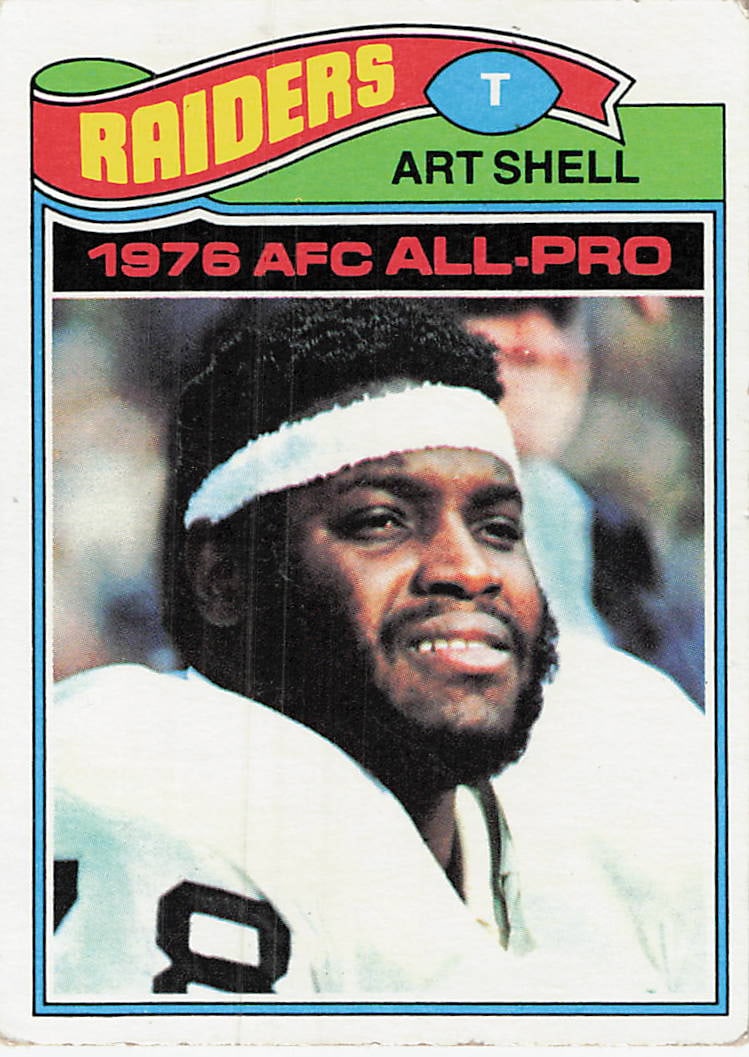 1977 Topps Art Shell Oakland Raiders Football Card: This is a 1977 Topps NFL football card featuring Hall of Fame offensive tackle Art Shell of the Oakland Raiders. The card, numbered 347, highlights his '1976 AFC All-Pro' achievement with a classic