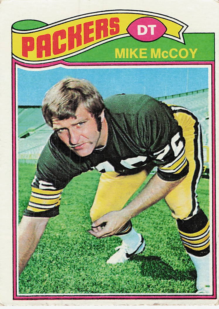 1977 Topps Mike McCoy Green Bay Packers Football Card: This is a 1977 Topps football card featuring Green Bay Packers defensive tackle Mike McCoy, card number 495. The card features a classic vertical design with a prominent team banner at the top and