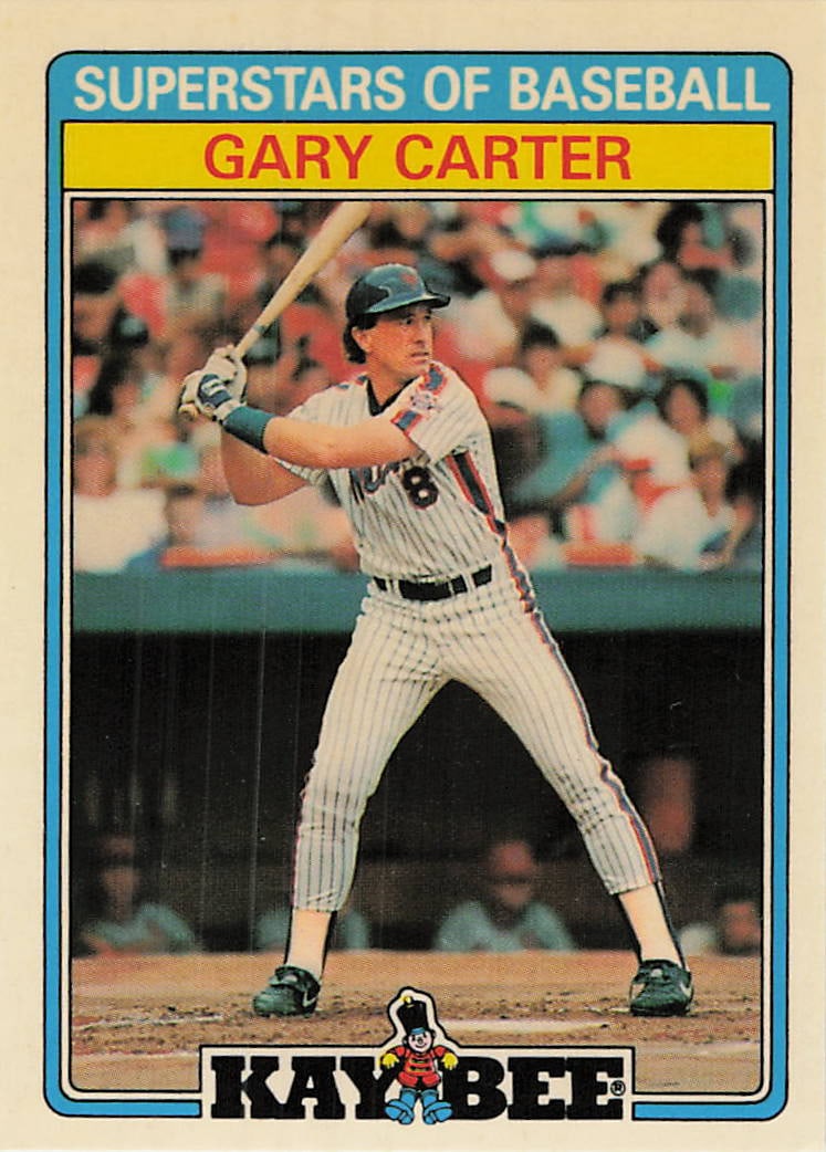1987 Kay-Bee Superstars Gary Carter Baseball Card: This is a 1987 Kay-Bee Superstars of Baseball card featuring Hall of Fame catcher Gary Carter of the New York Mets. The card captures Carter in his signature batting stance, highlighting his tenure wi