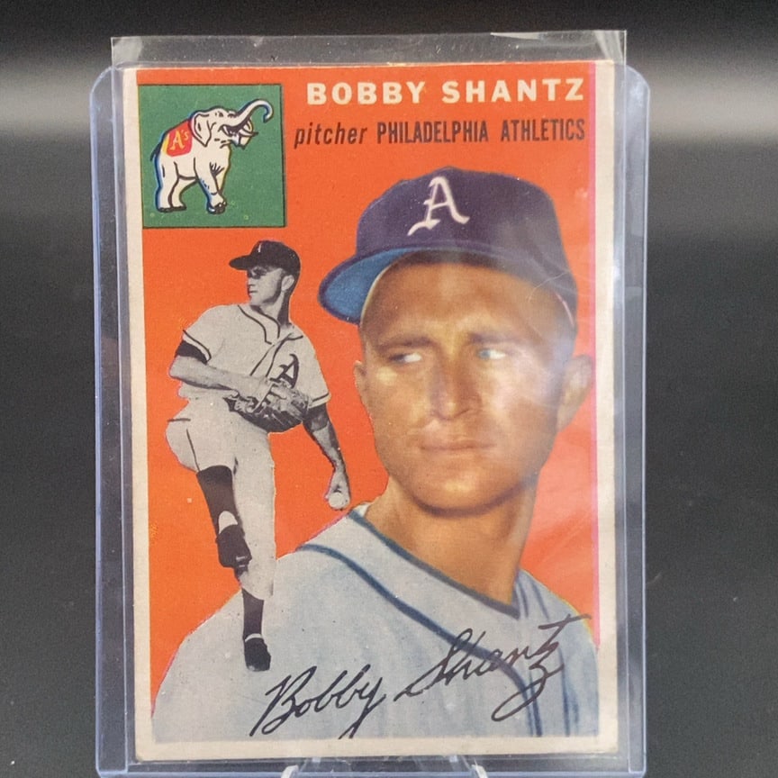 1954 Topps Bobby Shantz of the Philadelphia Athletics: This is a 1954 Topps baseball card featuring Bobby Shantz of the Philadelphia Athletics. The card includes a portrait image, a full-body action shot, and a facsimile autograph of the player. It is