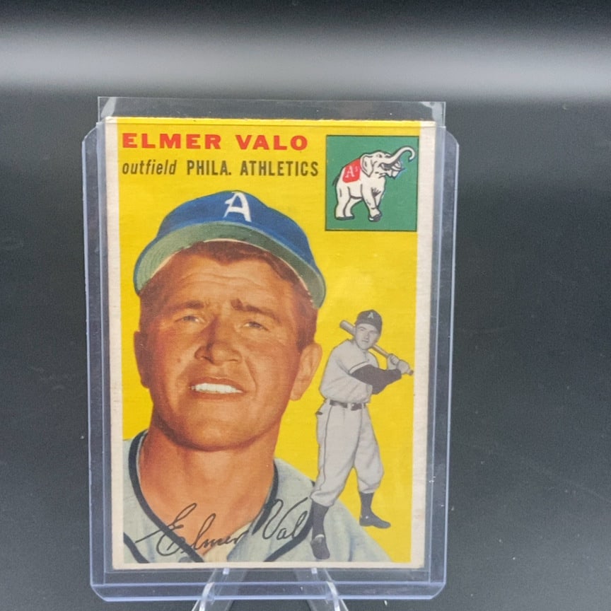 1954 Topps #145 Elmer Valo vintage baseball card: This is a 1954 Topps baseball card featuring outfielder Elmer Valo of the Philadelphia Athletics. The card features a vibrant yellow background with a team mascot icon in the upper right corner. It is