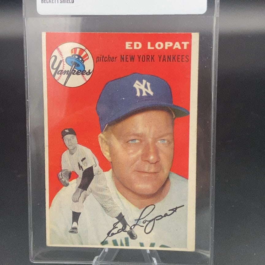 1954 Topps Ed Lopat (#5) baseball card: This is a 1954 Topps baseball card featuring New York Yankees pitcher Ed Lopat. The card showcases a portrait of the player alongside a full-body action pose and a facsimile signature on the front.