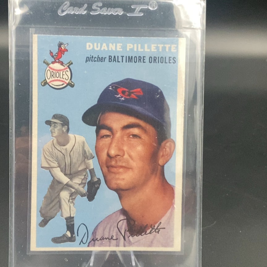 1954 Topps #107 Duane Pillette baseball card: This is a vintage trading card featuring Duane Pillette of the Baltimore Orioles. The card identifies him as a pitcher for the team and includes a portrait and a full-body action shot. The card is